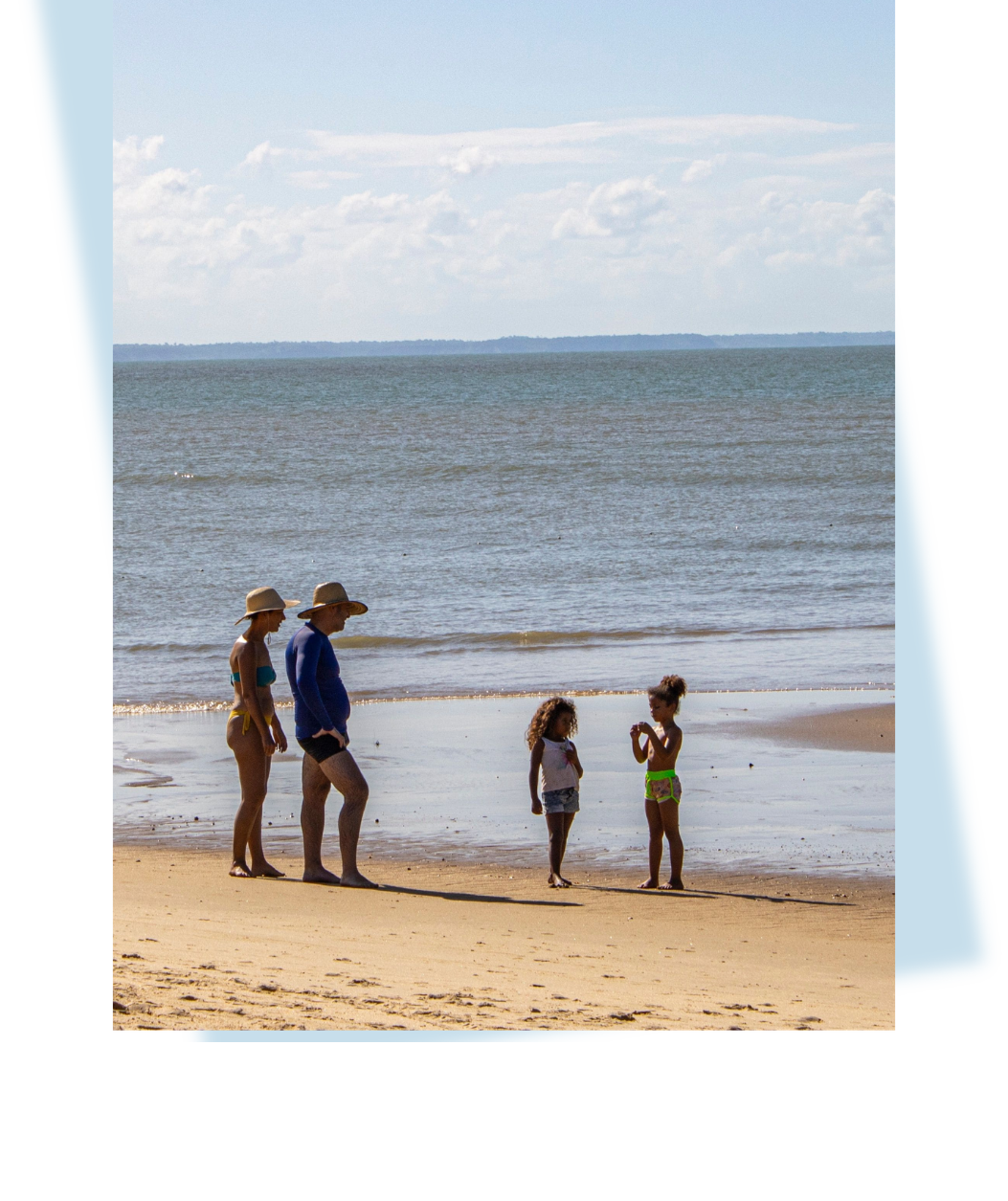 Grandparents and grandchildren together on a quiet beach in Central Vietnam