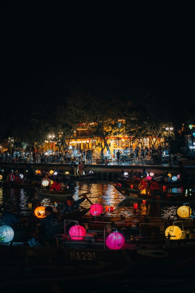 Traditional lantern boat ride on the Hoai River in Hoi An ancient town during a luxury family holiday in Vietnam.