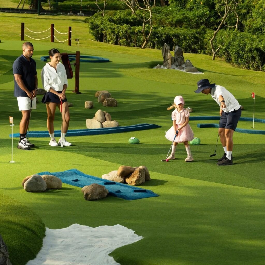A family playing mini golf at Hyatt Regency Danang, a great option when deciding where to stay in Vietnam with family.